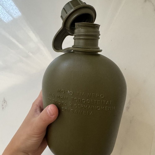Military-style khaki water canteen with cap