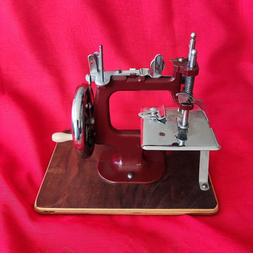 Mini vintage sewing machine made of wood and metal, functional
