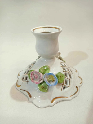 Porcelain candlestick used with pink and blue roses and gold finishes