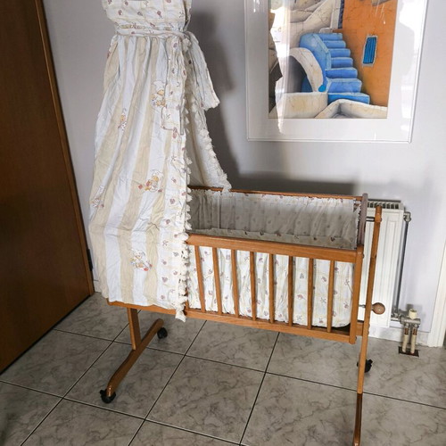 Wooden baby cot like new with wheels and mosquito net