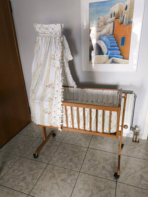 Wooden baby cot like new with wheels and mosquito net