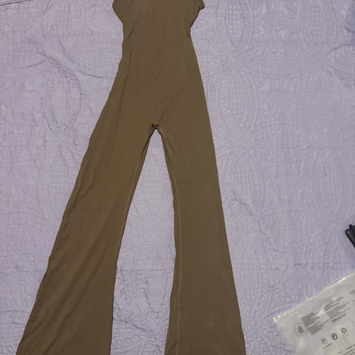 Gym Jumpsuit new with bell-bottom opening and open back, size S