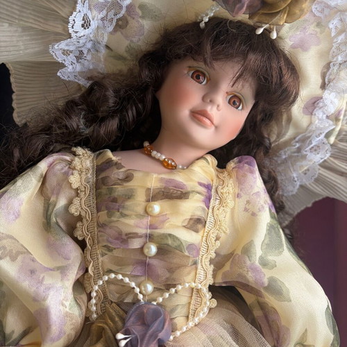 Porcelain doll like new with hat and umbrella