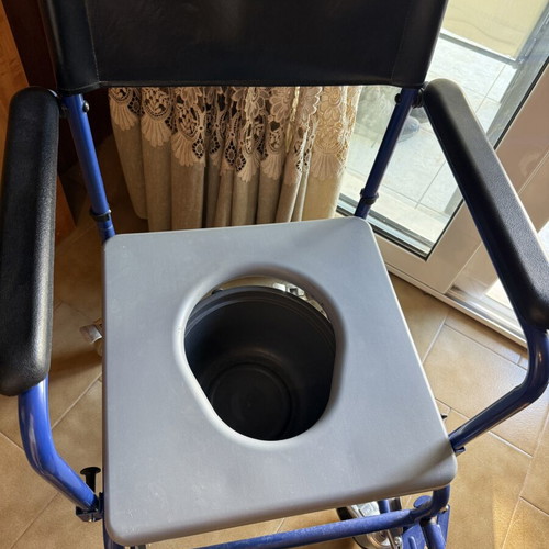 Bathroom wheelchair with bucket and cushion
