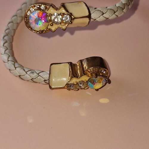 Bracelet made of white leather with gold clasps used