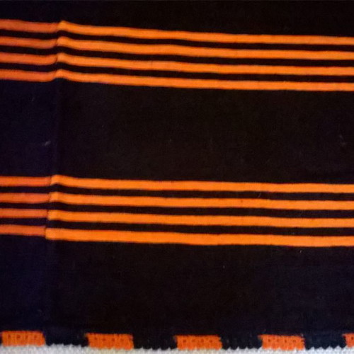Woven blanket used orange and blue in two joined pieces