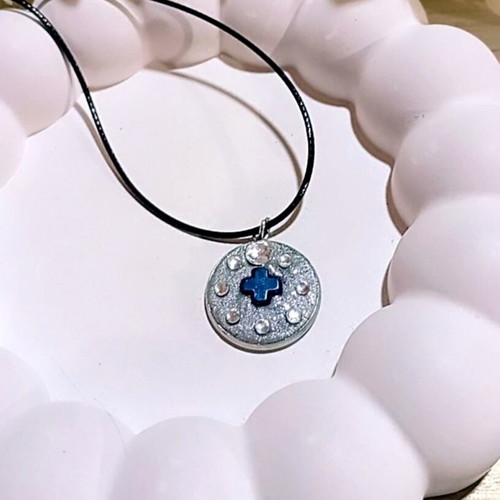 Handmade necklace with stainless steel iridescent silver motif and blue hematite cross