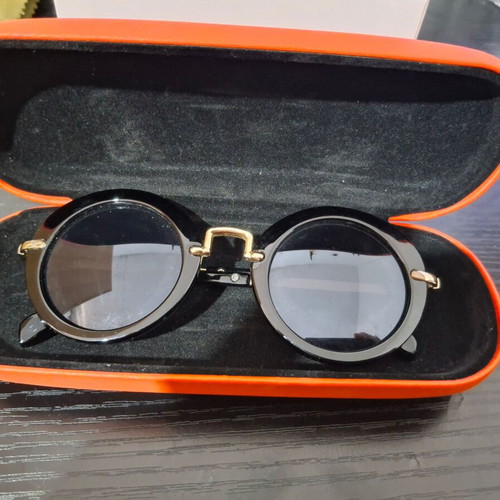 Women's sunglasses used with case and cleaning cloth, black and gold