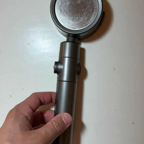 Modern shower head with stop button and flow selector, gunmetal