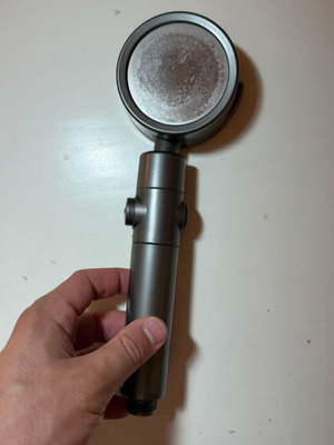 Modern shower head with stop button and flow selector, gunmetal