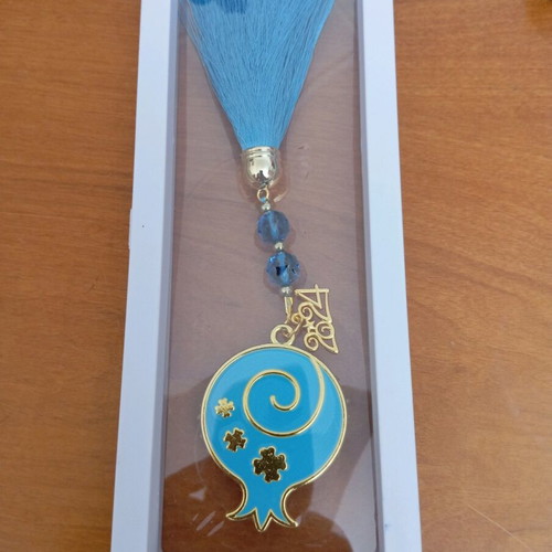 Decorative hanging like new with blue tassel and metal pomegranate