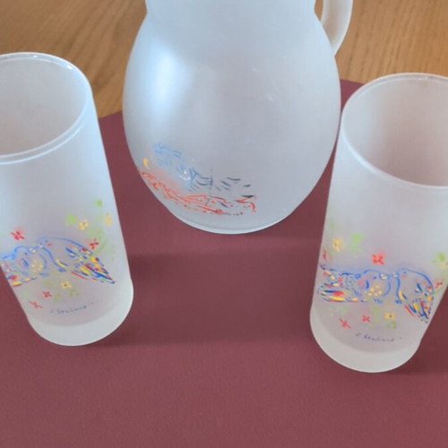 Glass pitcher and two glasses with Stathopoulos designs, like new