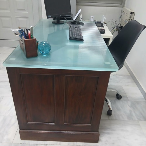 Desk made of walnut wood with green glass top and six drawers used
