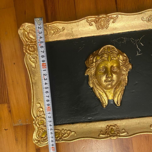 Gold-colored relief head wall art with black background, new