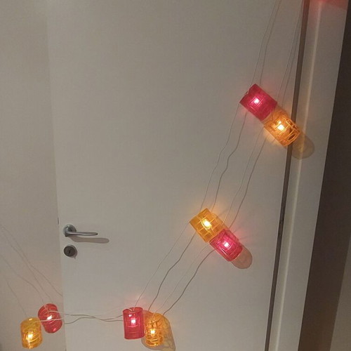 Outdoor balcony string lights used, red and orange