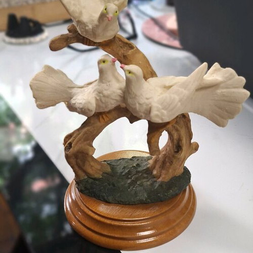 Decorative sculpture with white doves on wooden base like new