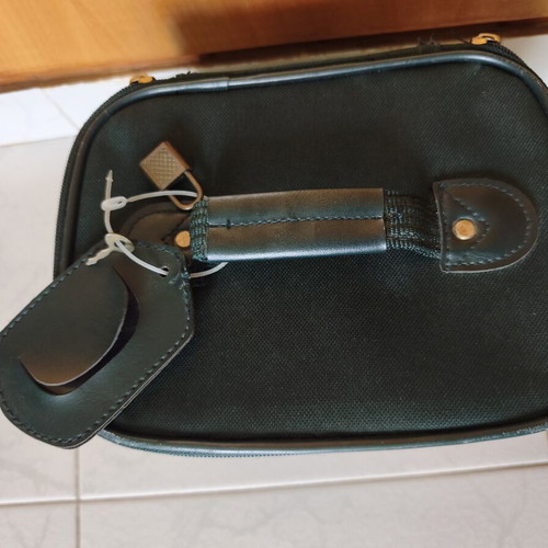 Toiletry bag used, green, fabric defect