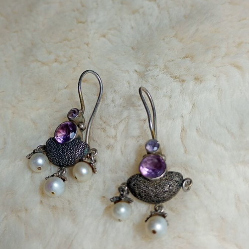 Silver earrings used with purple stones and pearls