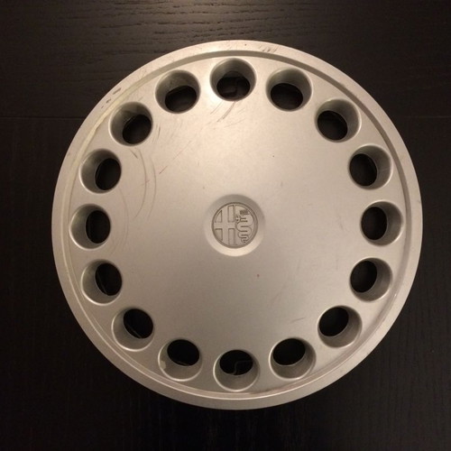 Alfa Romeo 75 hubcap used with scratches and marks