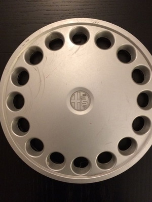 Alfa Romeo 75 hubcap used with scratches and marks