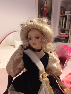 Porcelain doll collectible with base used