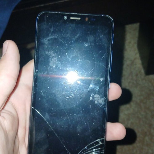 Alcatel phone used with cracks and scratches blue