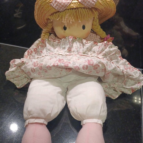 Doll like new with cotton clothes and straw hat