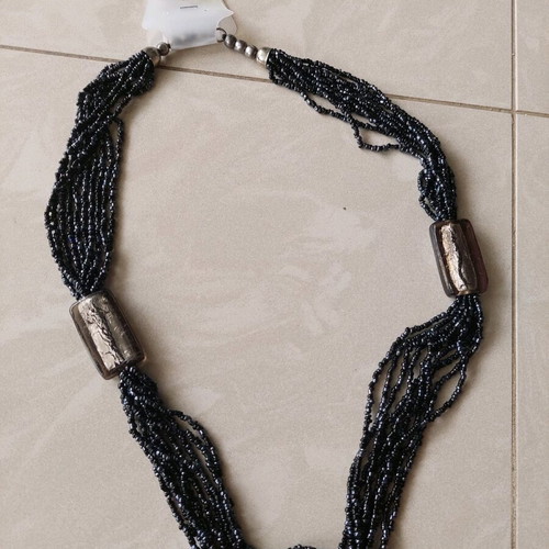 Necklace new with thin black beads and gray transparent stones