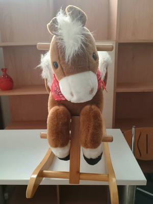Rocking horse plush on wooden base used