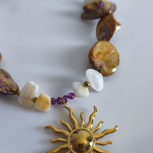Necklace with mother of pearl and gold steel sun pendant
