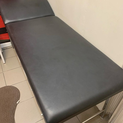 Examination bed used, black with inox folding legs