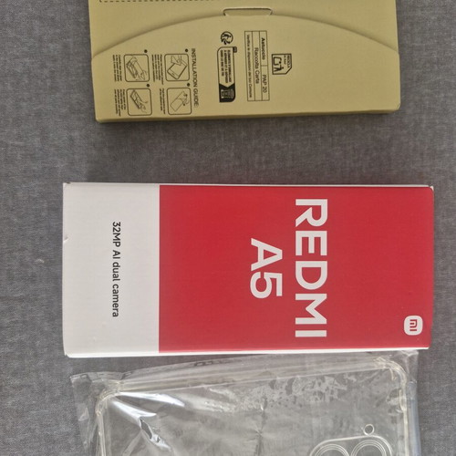 Redmi A5 64GB Sandy Gold smartphone with bonus glass protectors and case