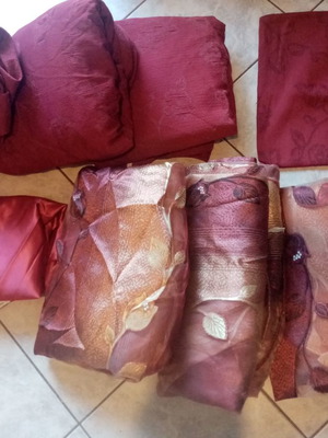 Living room decoration used with burgundy covers, curtains and pillowcase