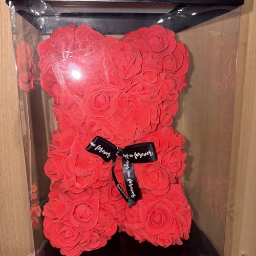 Handmade teddy bear made of red artificial roses