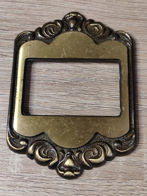 Vintage bronze switch frame used with marks and scratches