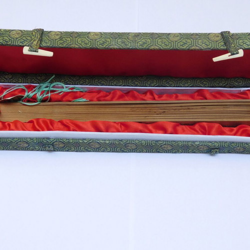 Traditional Chinese sandalwood fan with decorative tassel