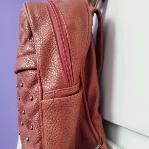 Backpack used red bag with quilted front zipper