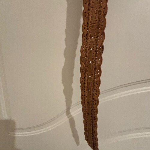 Tan belt like new with wavy edges and metal buckle