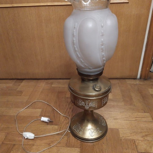 Vintage table lamp in old oil lamp style with glass, used