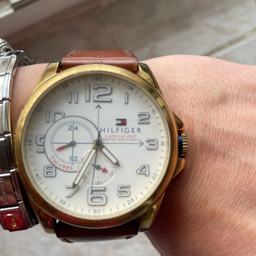 Tommy Hilfiger watch used with brown leather strap and gold dial