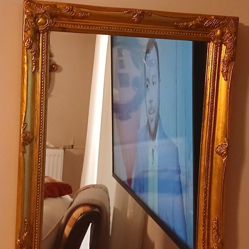 Wooden mirror with golden patina