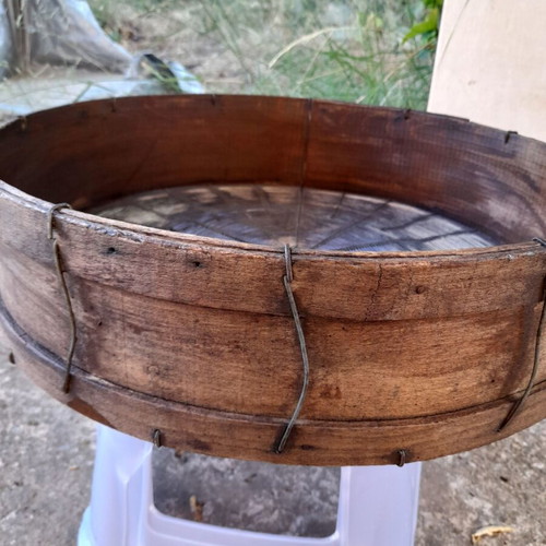 Handmade antique sieve with wooden frame and metal mesh