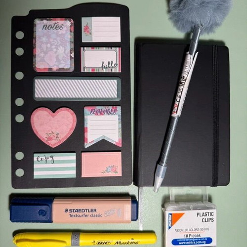Stationery set with notebook, pen, highlighters, clips, and post-it notes