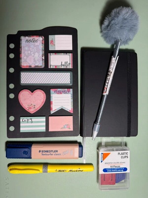 Stationery set with notebook, pen, highlighters, clips, and post-it notes
