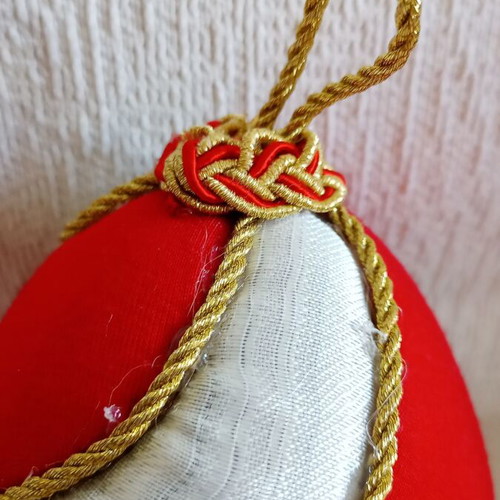 Decorative egg with spiral design used, red and gold