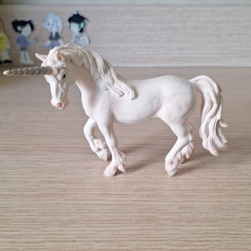 Schleich collectible unicorn figure with pink details and glitter