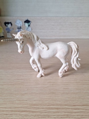 Schleich collectible unicorn figure with pink details and glitter