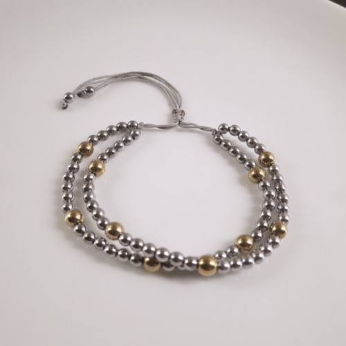 Double bracelet with silver and gold hematite beads, adjustable cord