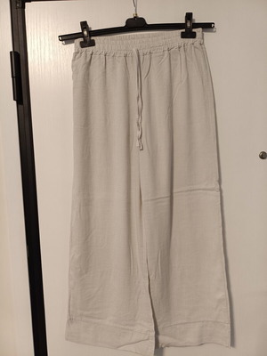 Women's loose beige pants with elastic waist and drawstring