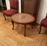 Oval living room coffee table with rattan and carved medallion